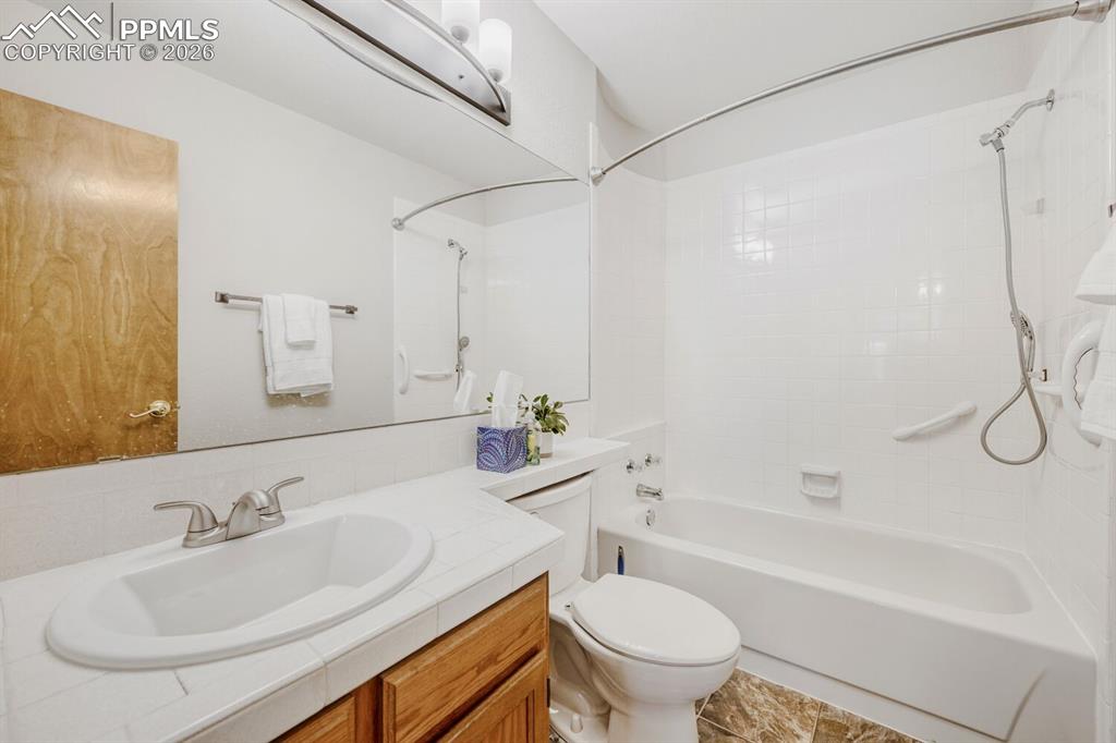 Image 20 of 34: Full bathroom with vanity and shower / bath combination