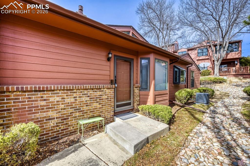 Image 28 of 34: Property entrance featuring brick siding