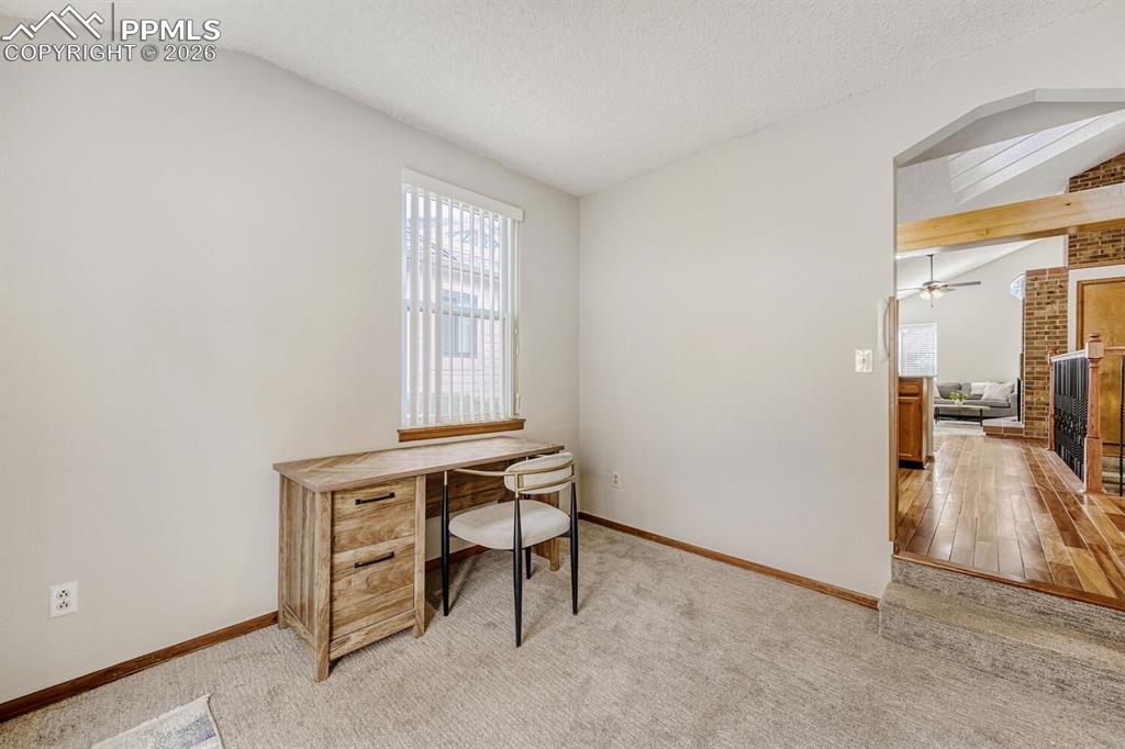 Image 8 of 34: Office featuring light colored carpet, beam ceiling, and a ceiling fan