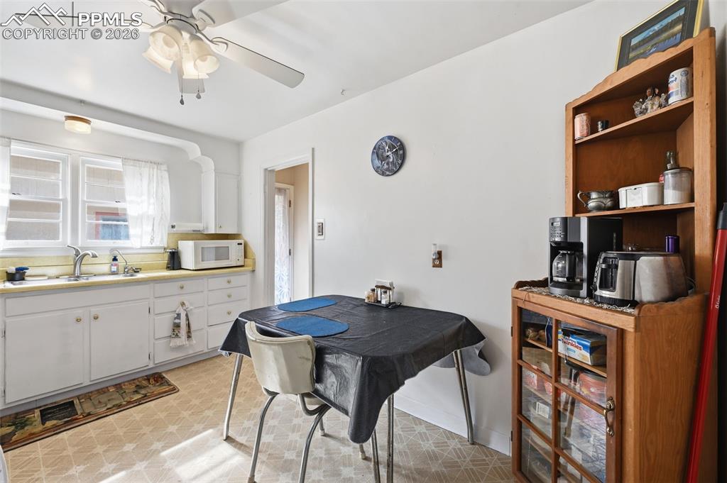 Image 11 of 23: Dining space with light flooring and ceiling fan