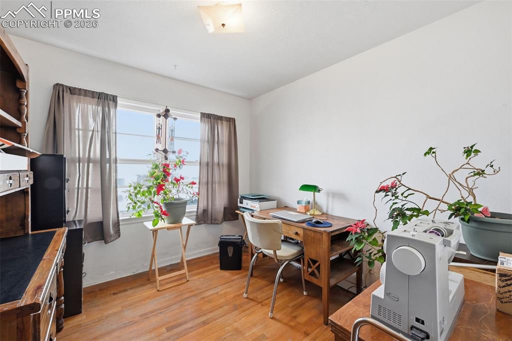 Image 14 of 23: Home office with light wood finished floors