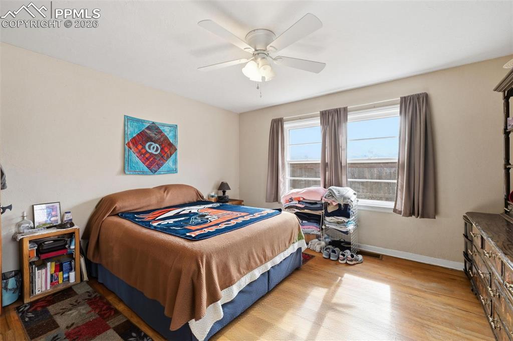 Image 16 of 23: Bedroom featuring hard wood floors and a ceiling fan