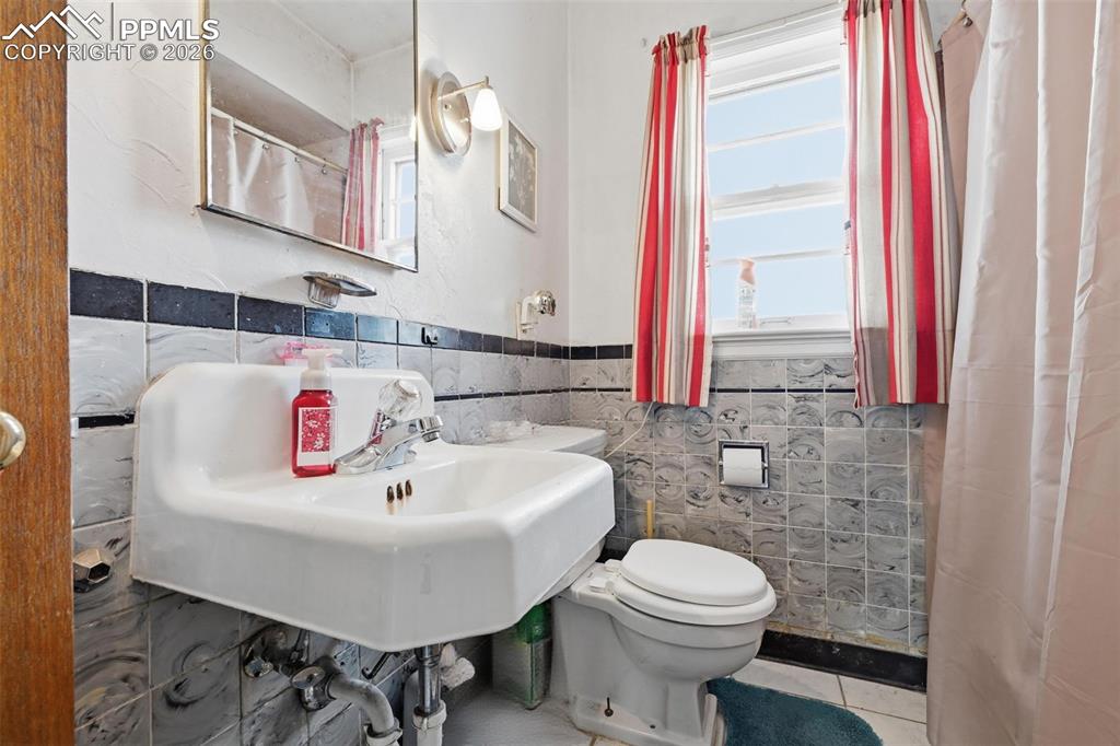 Image 17 of 23: Full bath featuring a shower tile walls, and tile patterned floors
