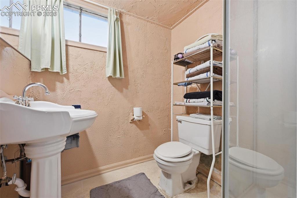 Image 20 of 23: Bathroom with shower and pedestal sink