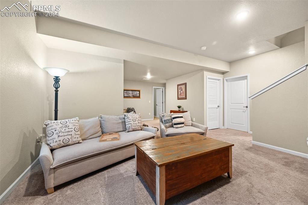 Image 31 of 43: Living room featuring light carpet