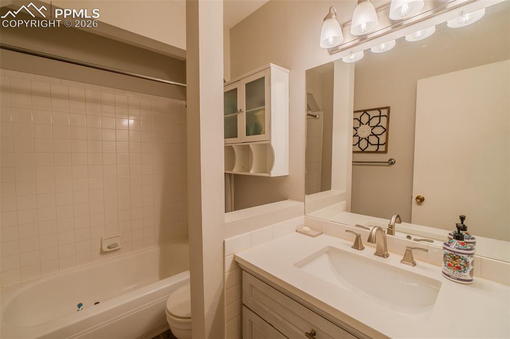 Image 12 of 31: Hallway Bathroom featuring a single vanity with an integrated sink, brushed