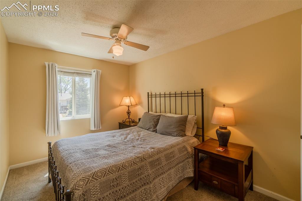 Image 17 of 31: 3rd Bedroom upstairs featuring a window with white trim, a ceiling fan with