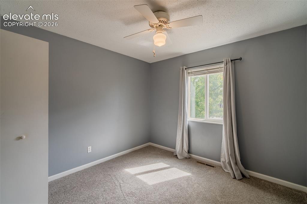 Image 18 of 42: Wall-to-wall carpeting, a ceiling fan with integrated lighting, and a singl