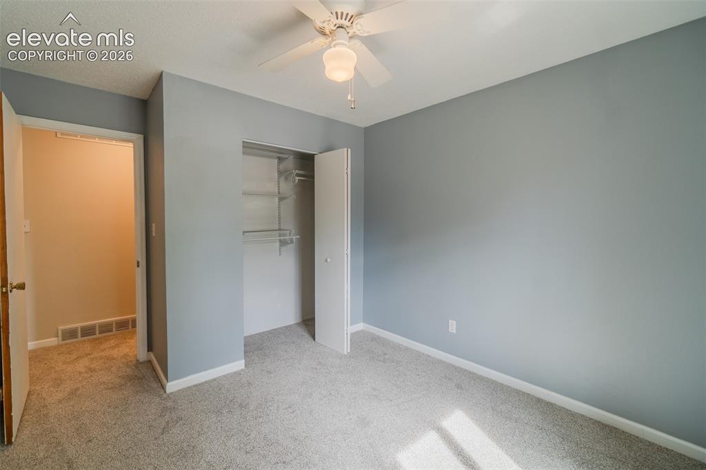 Image 19 of 42: Plush carpet flooring paired with light gray walls