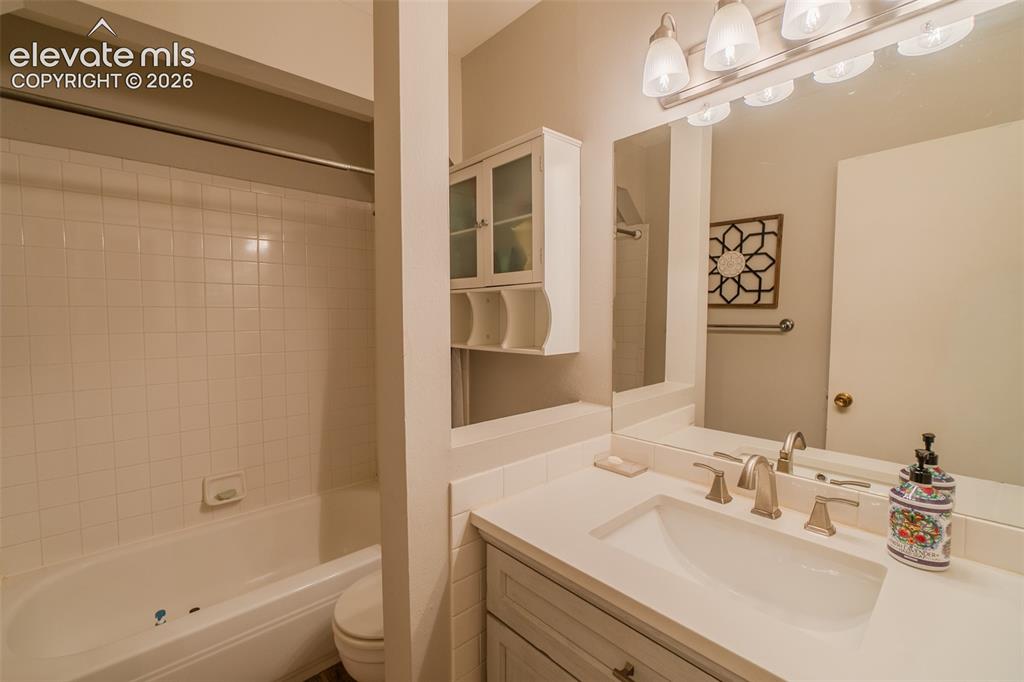 Image 20 of 30: Hallway Bathroom featuring a single vanity with an integrated sink, brushed