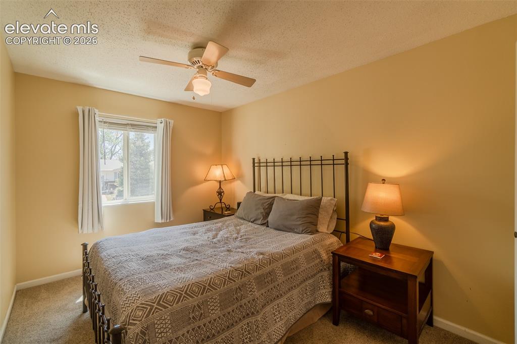 Image 24 of 30: 3rd Bedroom upstairs featuring a window with white trim, a ceiling fan with
