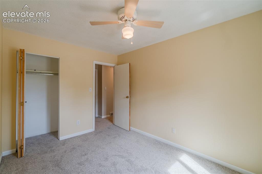 Image 24 of 42: Carpeted flooring, neutral wall tones, ceiling fan with light fixture, buil