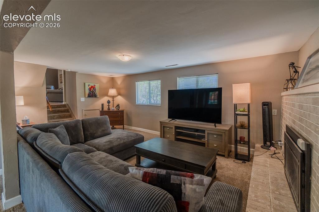 Image 25 of 30: Spacious living area on the lower level featuring neutral carpeting, recess