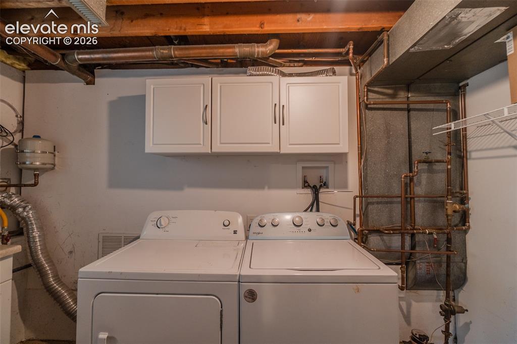 Image 27 of 30: Washer dryer will stay. Copper pipes. Tankless water heater, expansion ta