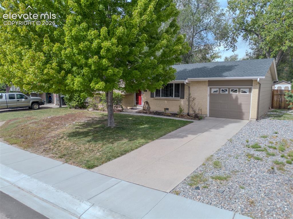 Image 35 of 42: Attached single-car garage featuring a tan overhead door