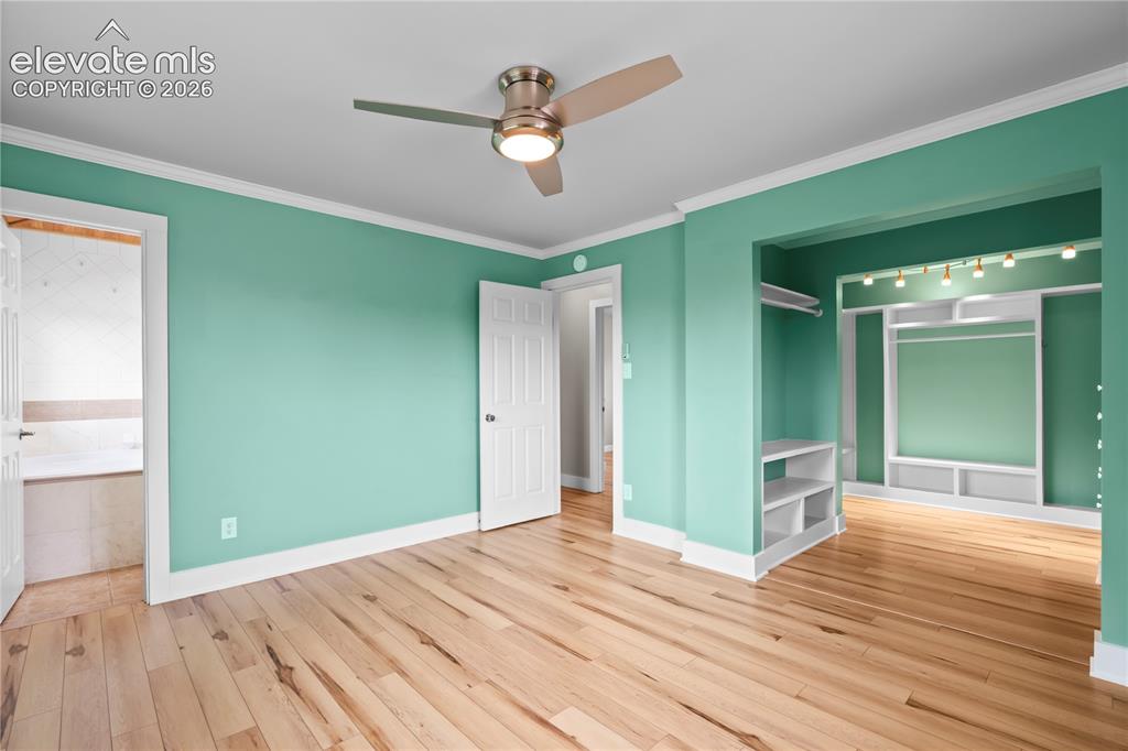 Image 17 of 31: Hardwood flooring throughout, complemented by a modern ceiling fan with int