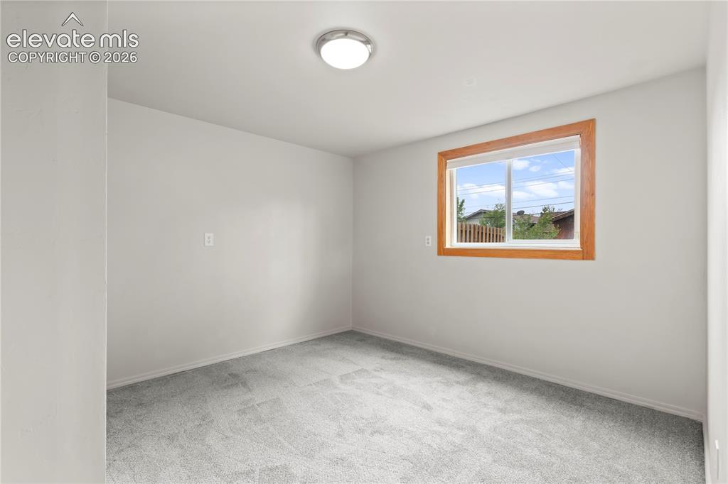 Image 28 of 31: Room featuring light gray wall paint, gray carpet flooring, a window with a