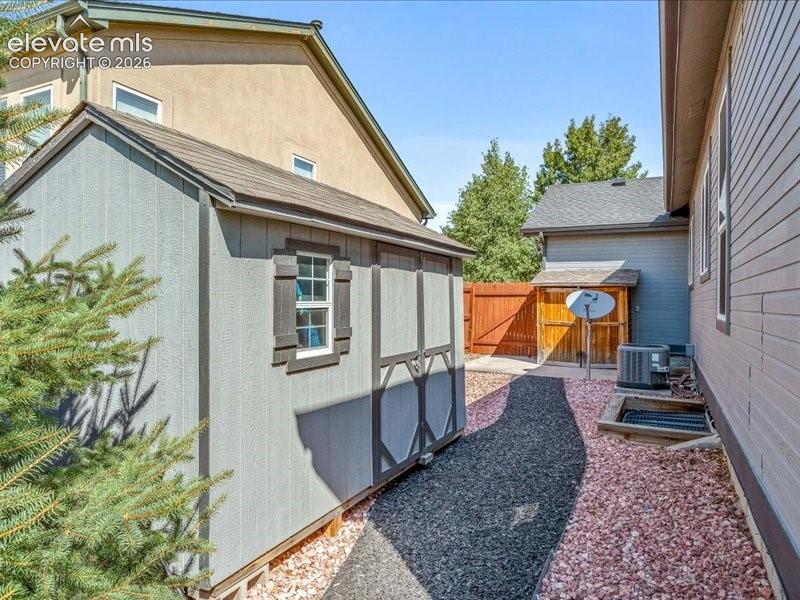 Image 31 of 34: Side Yard with sheds