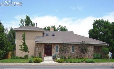 Image 1 of 3: Single story home with stucco siding and a chimney