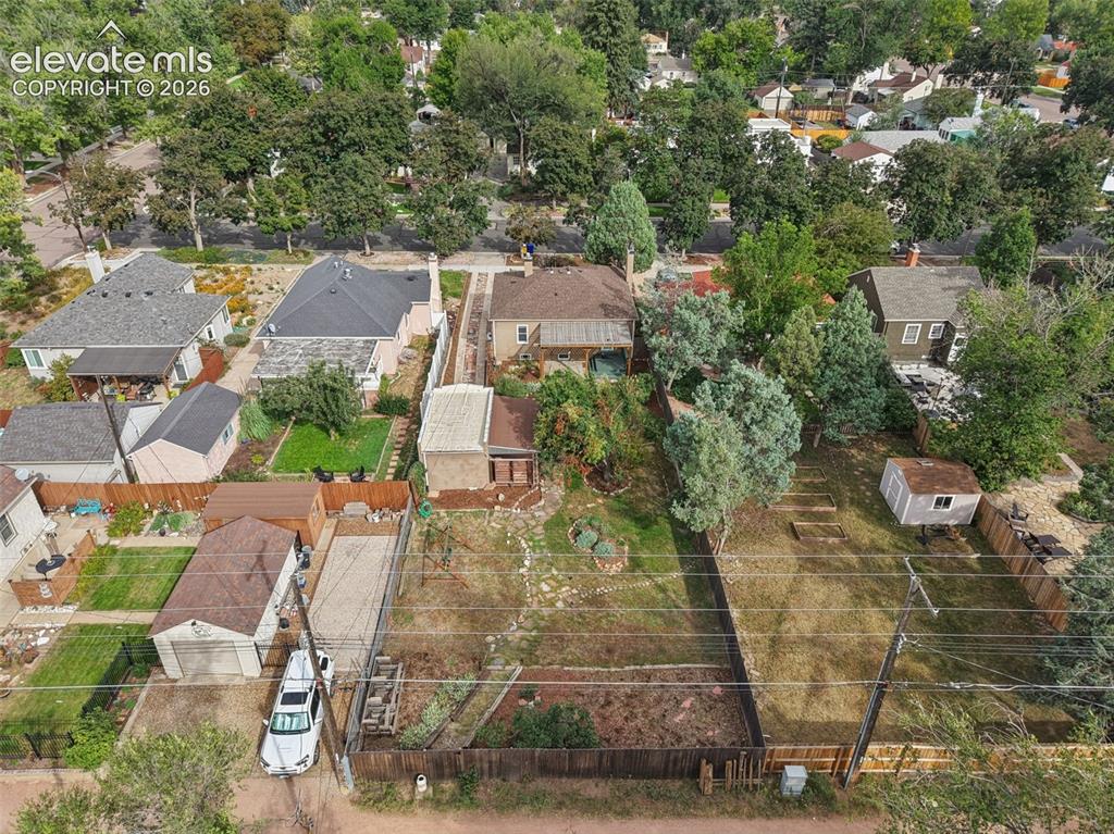 Image 45 of 50: Expansive lot featuring mature trees, a detached garage, and a fenced perim