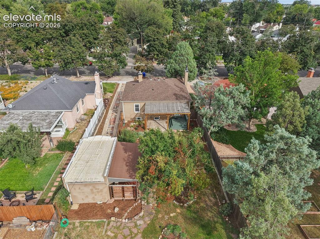 Image 48 of 50: Expansive property featuring a rear patio with wooden decking, mature lands