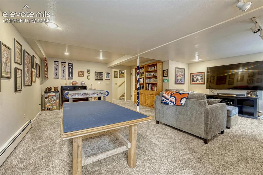 Image 17 of 48: Spacious lower-level area with recessed lighting, light-toned carpeting, an
