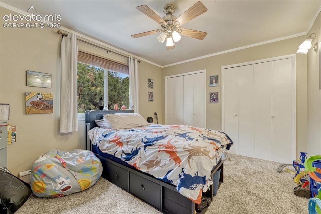 Image 24 of 48: Carpeted interior space featuring a window with blinds, a ceiling fan with