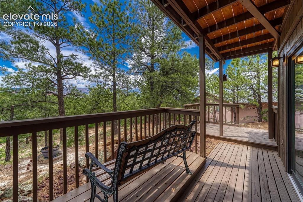 Image 33 of 48: Expansive outdoor deck featuring wood-finish flooring, protective railing,