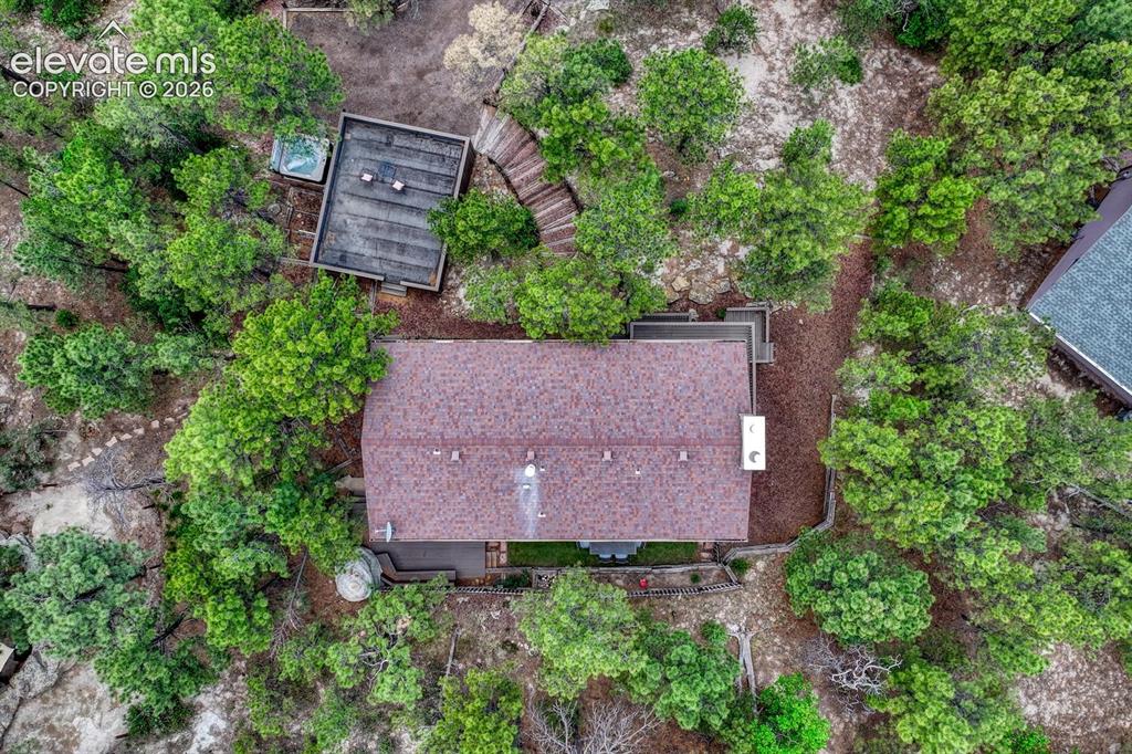 Image 40 of 48: Property featuring a brown shingle roof, a secondary structure with a flat