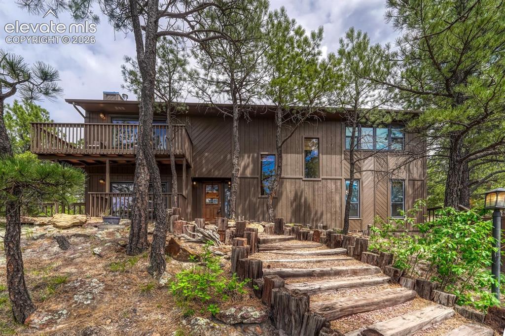 Image 48 of 48: Multi-level residence featuring a wood-panel exterior, multiple balconies w