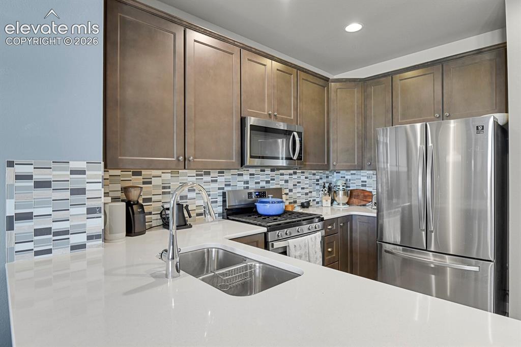 Image 11 of 26: Plenty of storage space in thee beautiful wood cabinets 