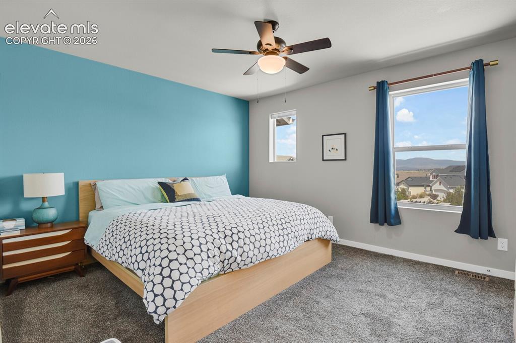 Image 18 of 26: Primary bedroom with walk in closet and private bath.