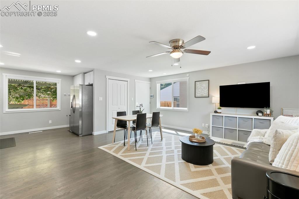 Image 4 of 39: Living area with recessed lighting, wood finished floors, and a ceiling fan