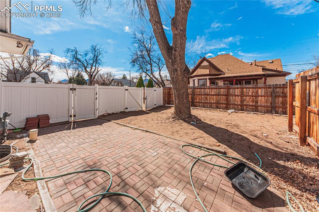 Image 3 of 39: View of patio with a gate and a fenced backyard