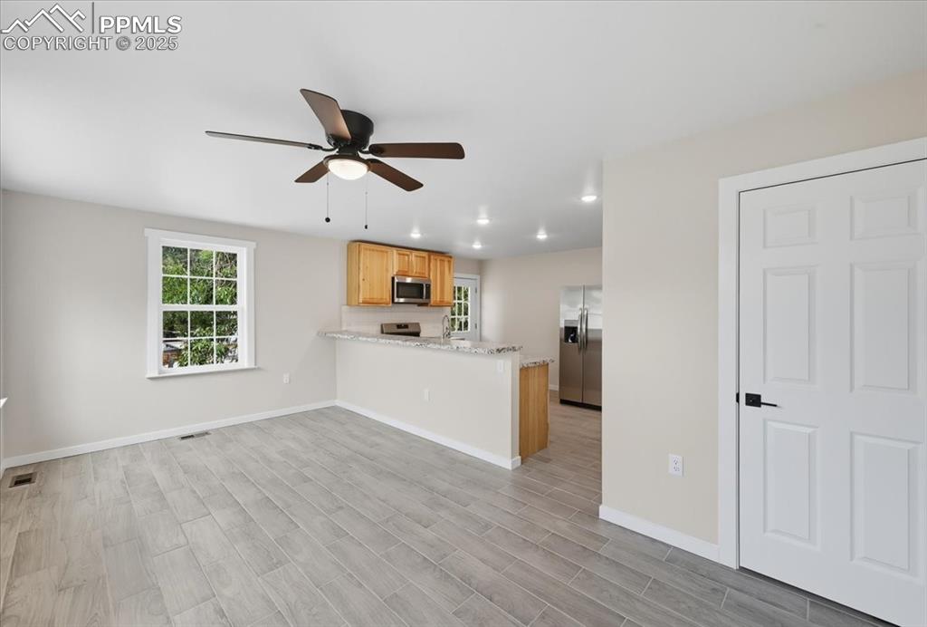 Image 30 of 48: Kitchen is open to the living room.