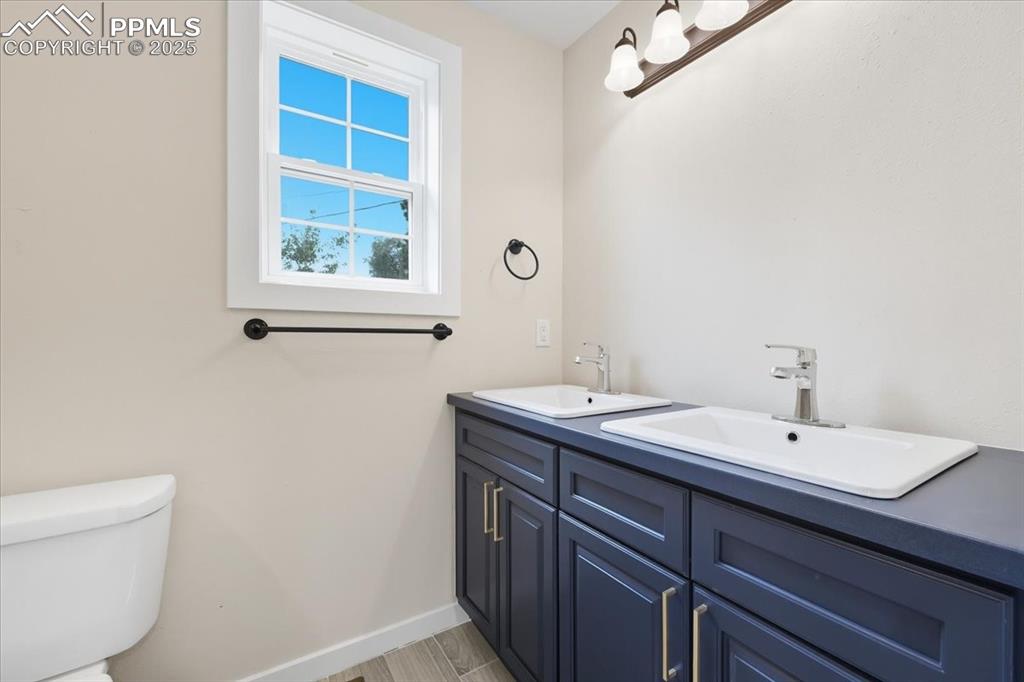 Image 31 of 48: Full bathroom with double vanity.
