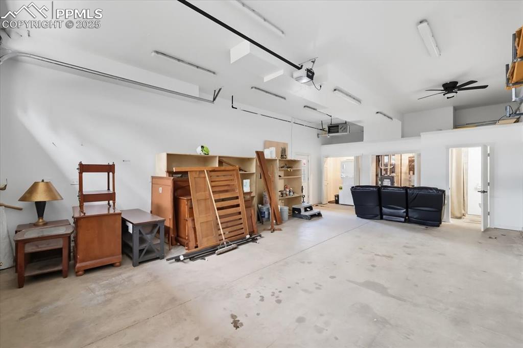 Image 41 of 48: Large garage with washer/dryer and 3/4 bathroom.