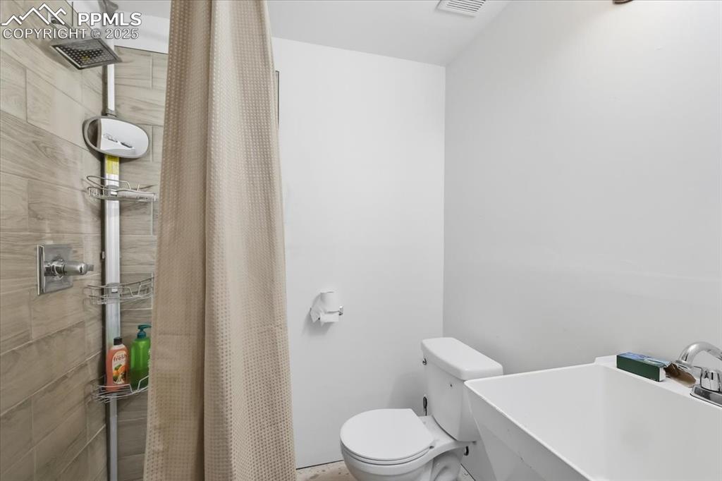 Image 43 of 48: 3/4 bathroom in the garage.