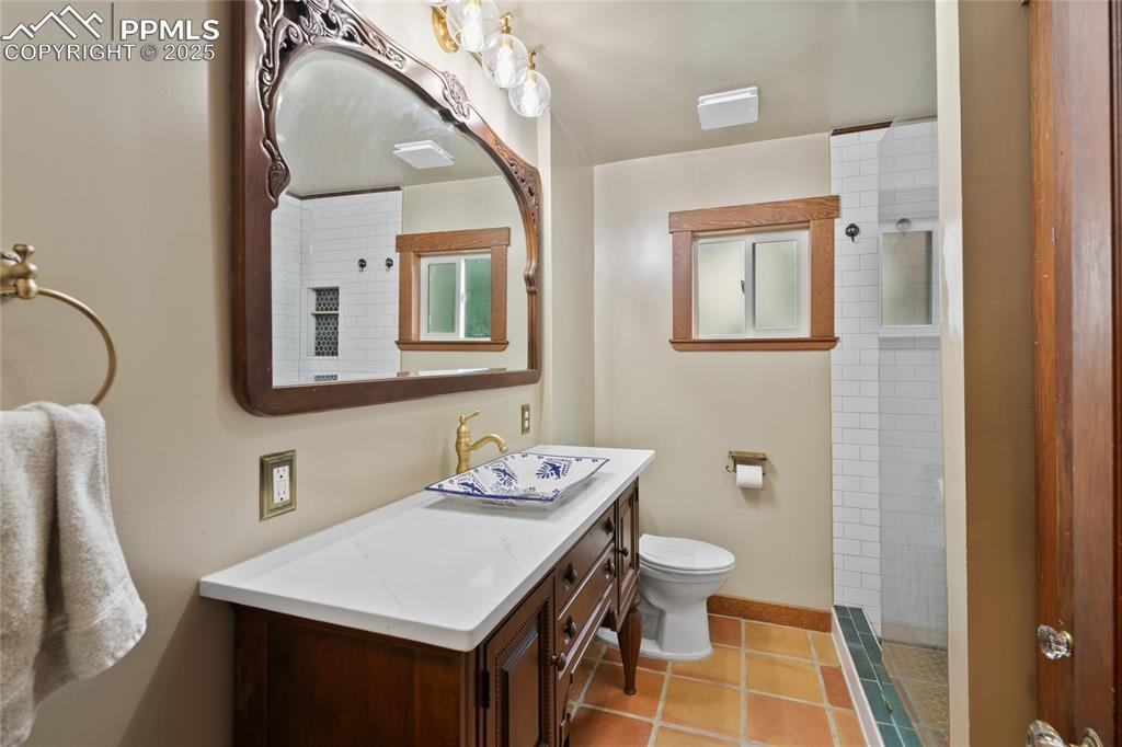 Image 14 of 43: Custom vanity in remodeled bathroom