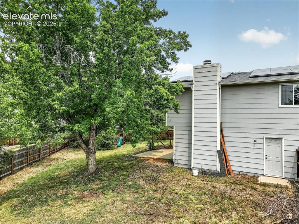 Image 28 of 50: Side Yard and Garage Exit Door