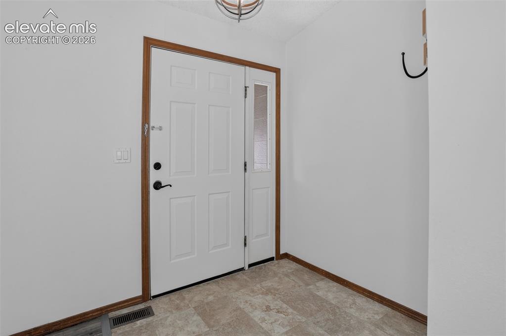 Image 4 of 50: Welcoming Entryway that has a Handy Coat & KeyRack