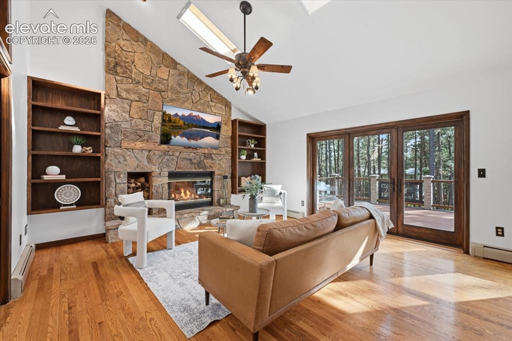 Image 10 of 46: Vaulted ceilings with skylights, stone-faced fireplace, built-in shelving,