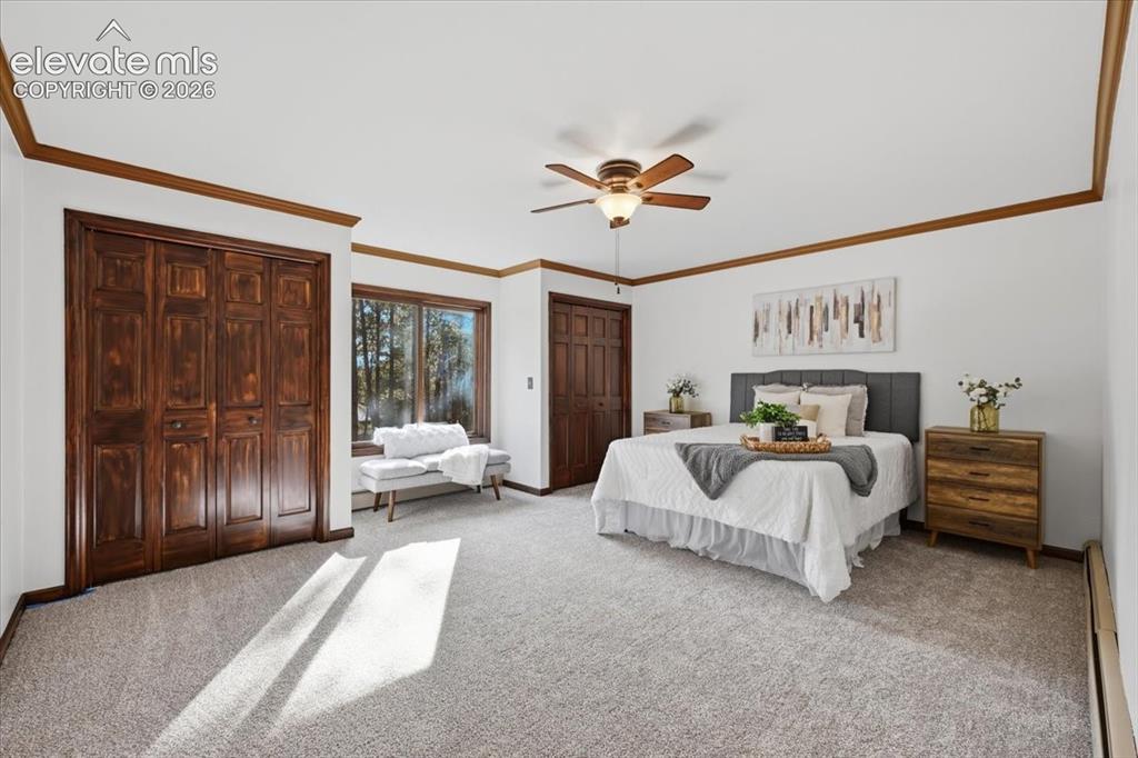 Image 15 of 46: Spacious room featuring wood-finish trim, multiple windows, a ceiling fan,