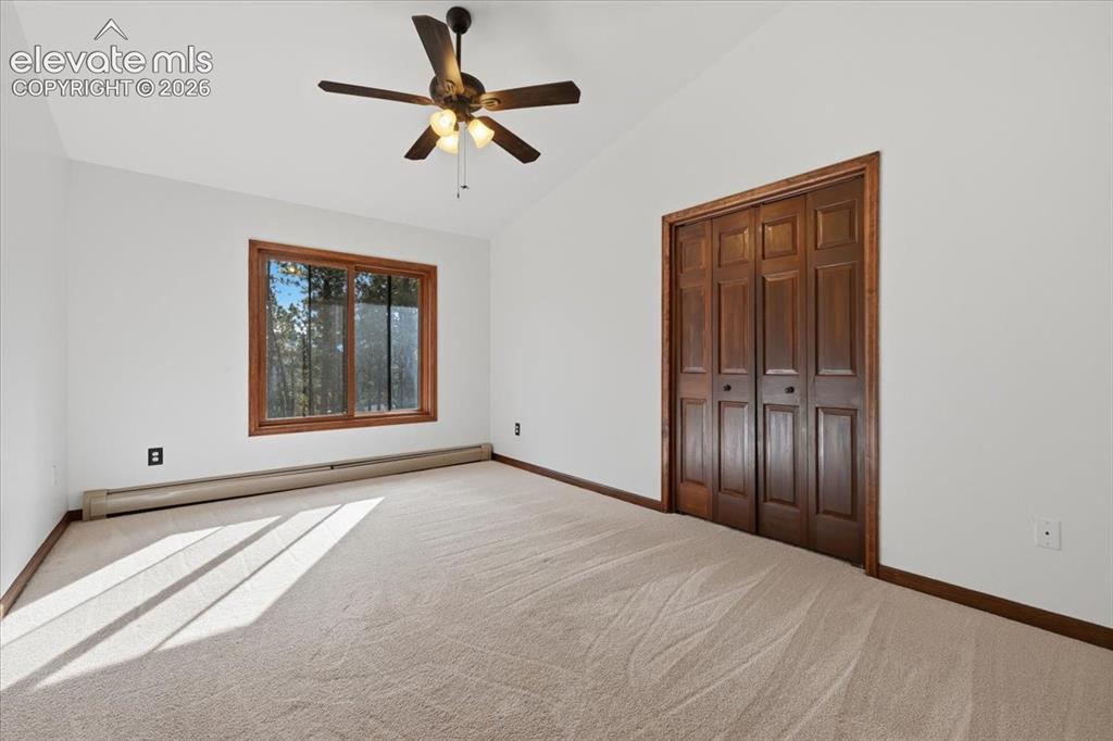 Image 23 of 46: Vaulted ceiling with an attached ceiling fan and light fixture, featuring a