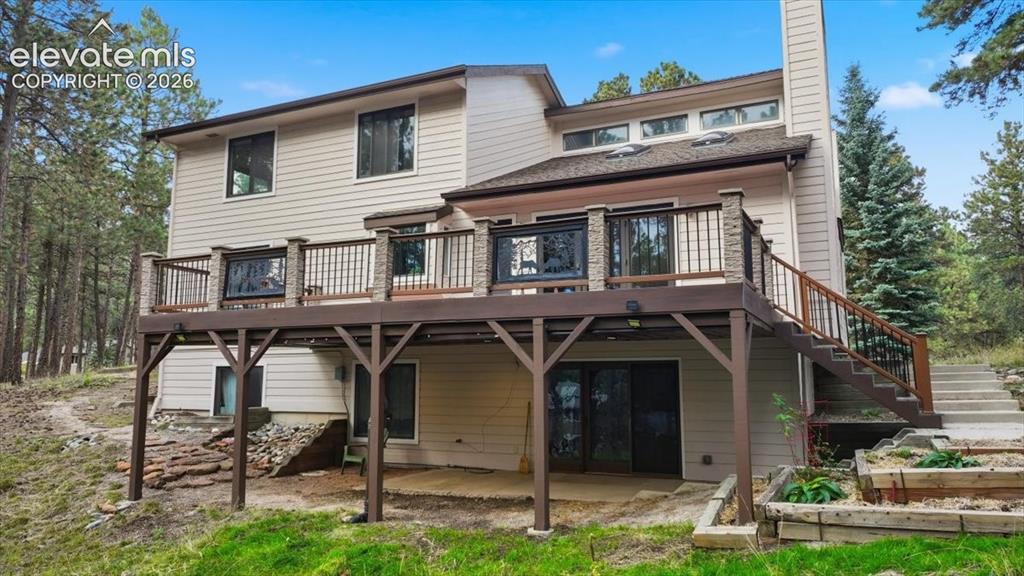Image 4 of 46: Multi-level exterior with light-colored siding, a brown shingle roof, and m