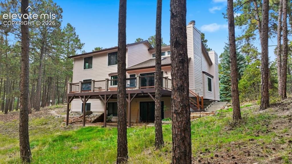 Image 43 of 46: Multi-level exterior with siding, a large elevated deck with metal railings
