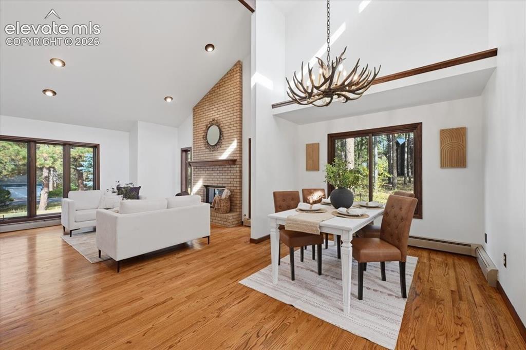 Image 8 of 46: Vaulted ceilings, exposed brick fireplace, recessed lighting, wood-finish f