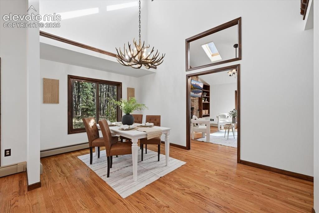 Image 9 of 46: Hardwood flooring throughout, recessed ceiling lighting, wood staircase wit