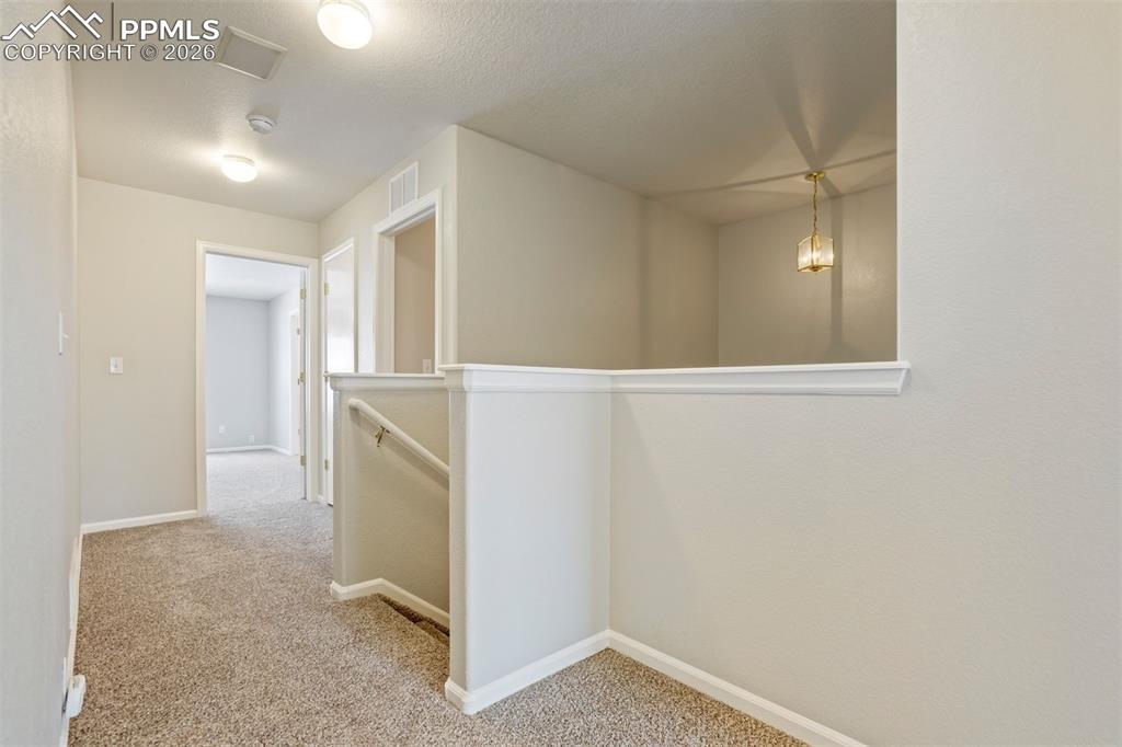 Image 14 of 31: Upstairs landing area that leads to the Primary Suite. 