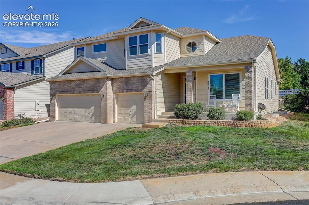 Caption: Multi-level exterior featuring siding and brick accents
